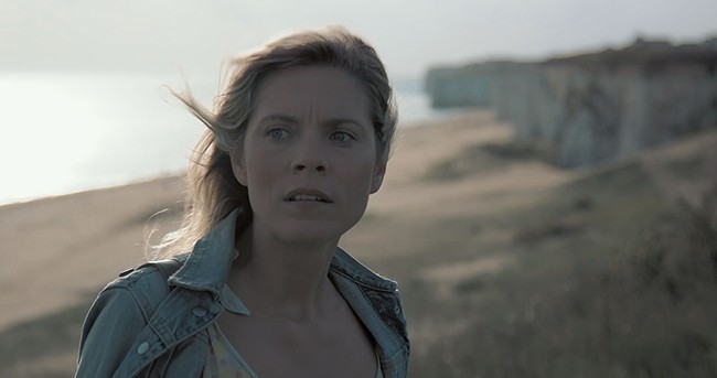 Image of woman looking into the distance with a worried expression