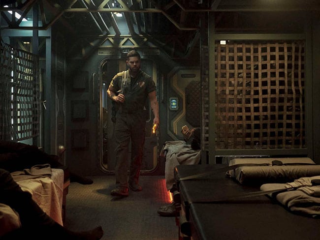 Amos travels back to Earth on a Ferry, in The Expanse.  He is checking into a cabin on one the lower decks, and looking for a bunk.  Like others in the crew he adds to the Exodus from Tycho.